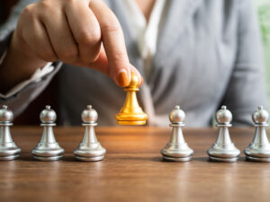 Person moving a single chess piece to illustrate the strategic role of a managed IT services provider