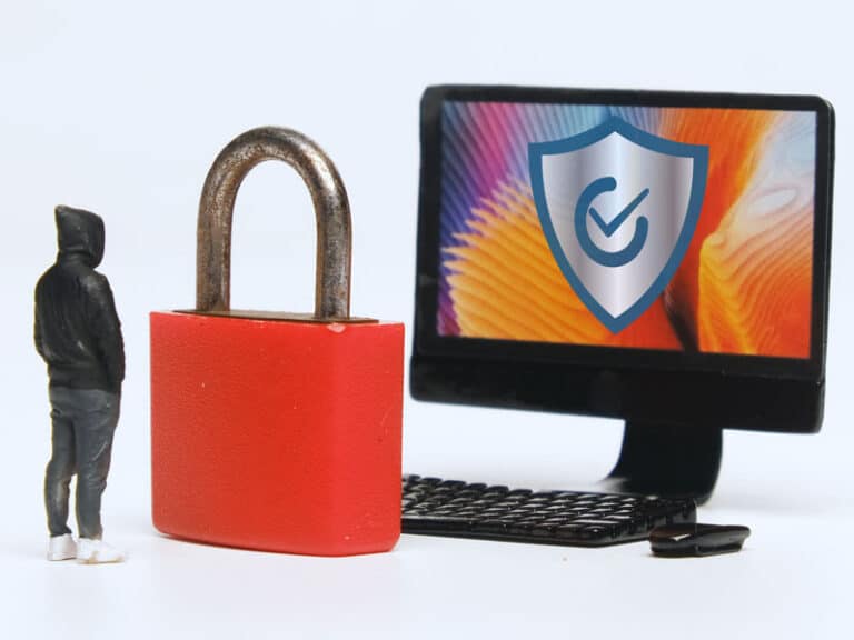 a small hacker standing front of a huge padlock protecting a computer to illustrate cybersecurity solutions in Charlotte