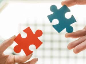 two jigsaw pieces about to be joined, to illustrate benefits of partnering with a HIPAA-compliant IT provider