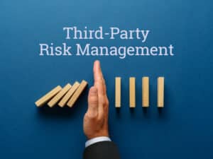 hand stopping a line of dominos from falling to illustrate third-party risk management