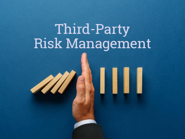 hand stopping a line of dominos from falling to illustrate third-party risk management