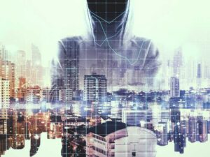 vague hooded figure behind a cityscape to illustrate the need for identity and access management in business security