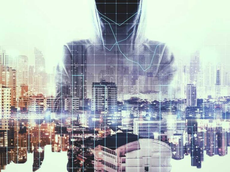 vague hooded figure behind a cityscape to illustrate the need for identity and access management in business security