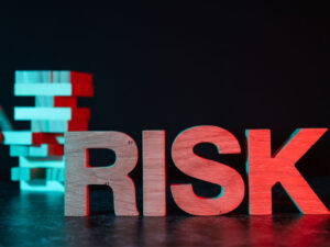 building blocks with RISK in Red letters beside them to illustrate common risks in identity management